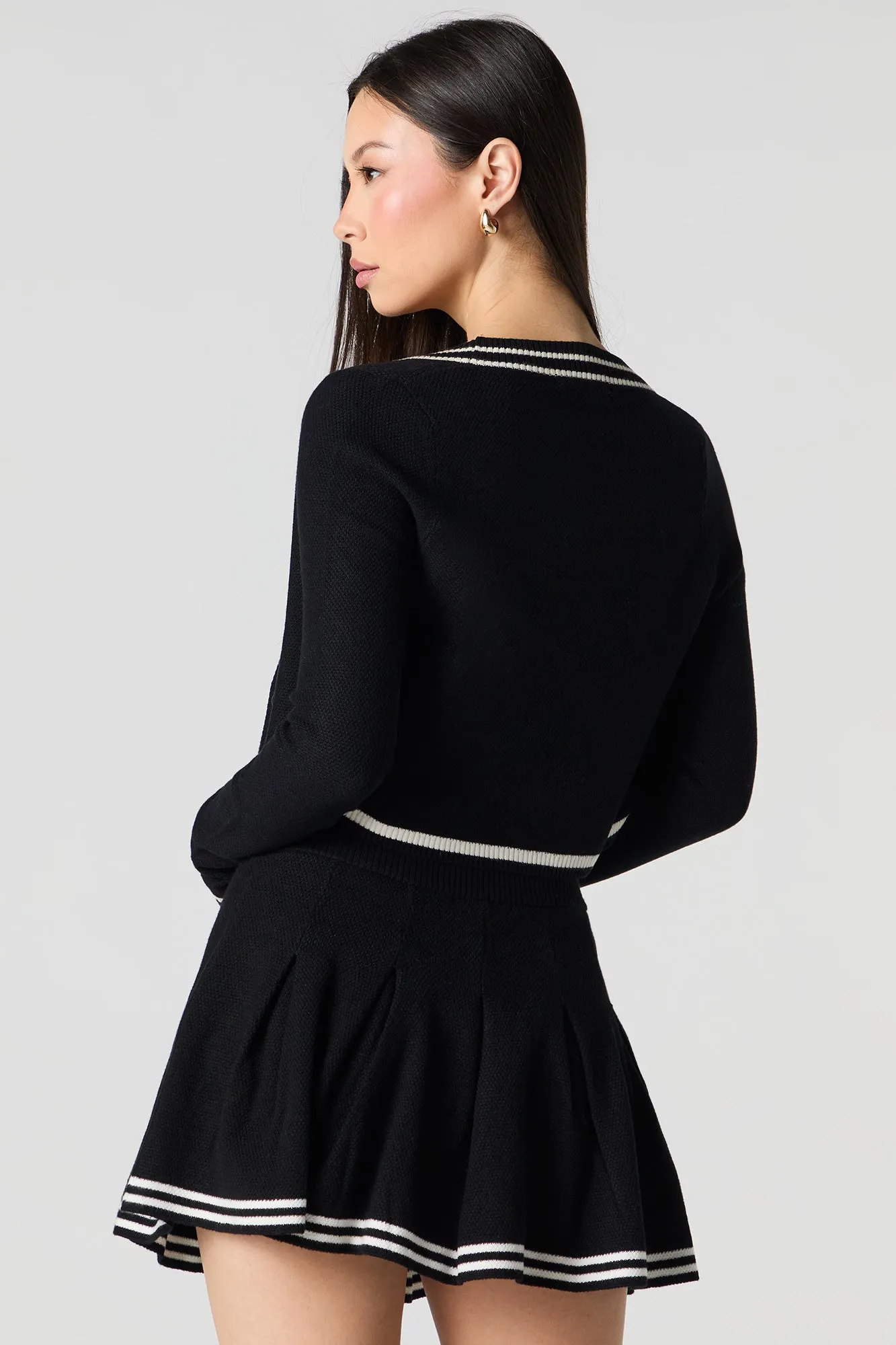 Jupe-short de tennis plissée avec liséré en tricot rayé