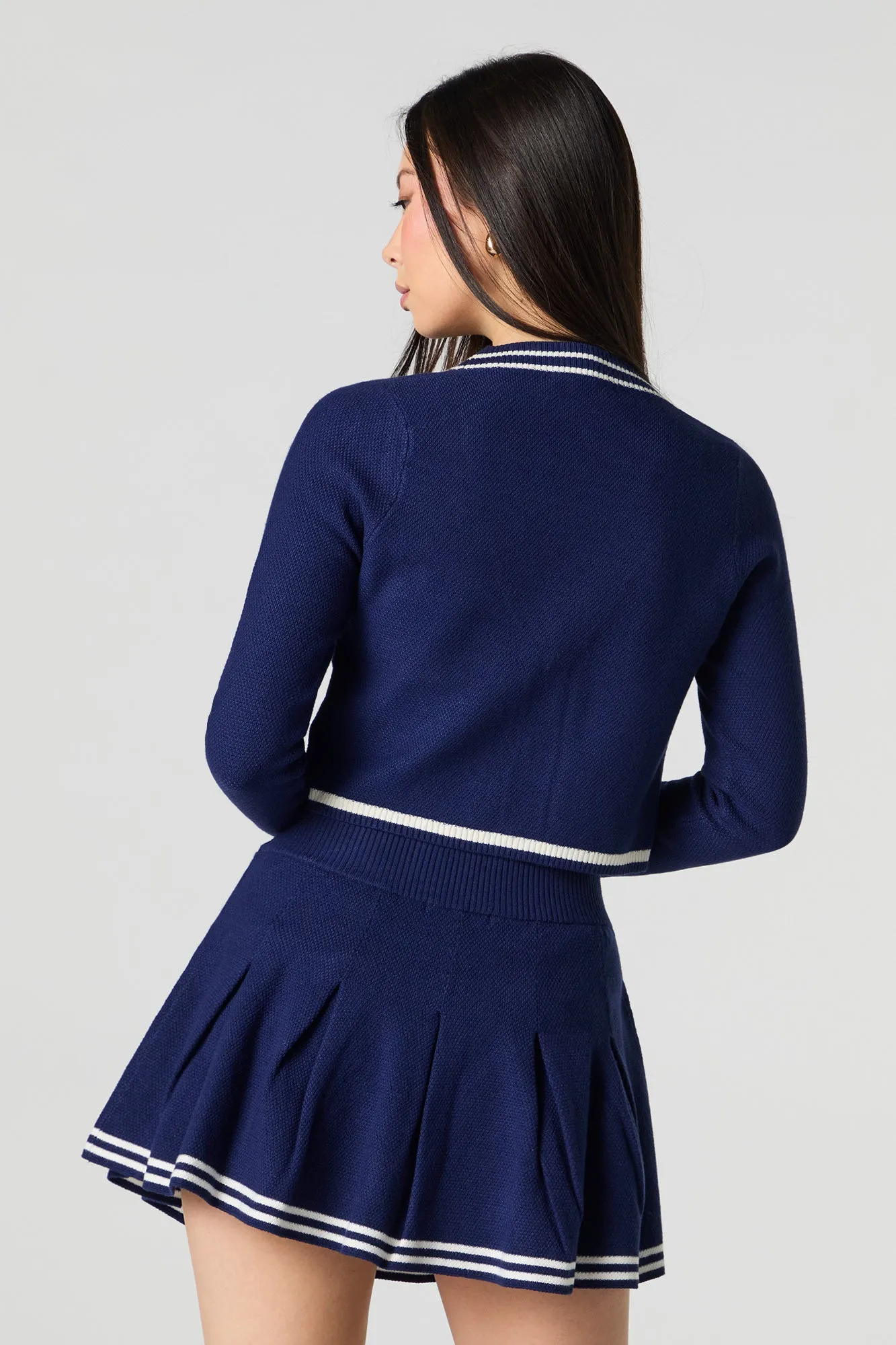 Jupe-short de tennis plissée avec liséré en tricot rayé